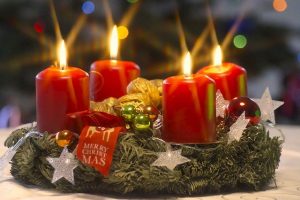 Advent wreaths usually have four candles around the perimeter and one white candle in the center.