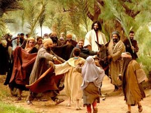 Jesus riding a donkey during His triumphal entry.